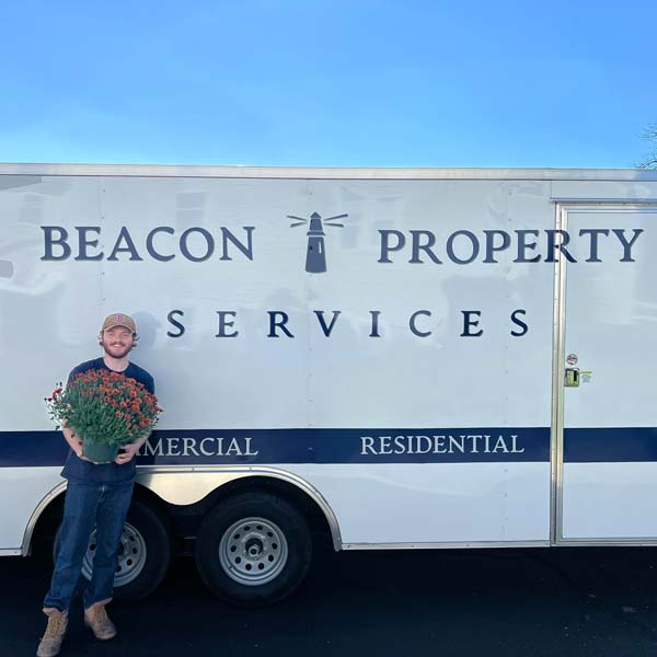 Beacon Property Services employee by company truck